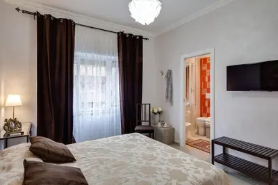 a bedroom with a bed and a large window at Dreamsrome Suites in Rome