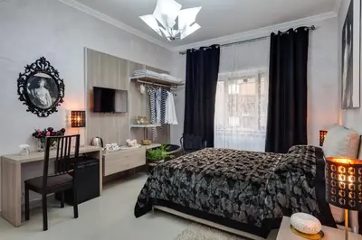 a bedroom with a bed and a desk and a chair at Dreamsrome Suites in Rome