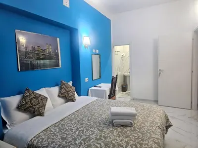 a blue room with a bed and a mirror at Relax ON 247 in Rome