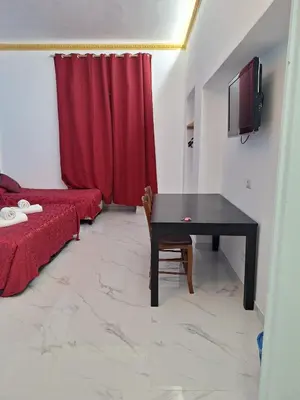 two beds in a room with red sheets and towels at Relax ON 247 in Rome