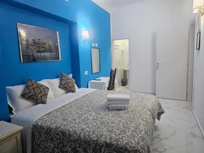 a blue bedroom with a bed with towels on it at Relax ON 247 in Rome