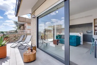 a glass extension of a house with a living room at Rome as you feel - Vatican Terrace Apartments with View in Rome