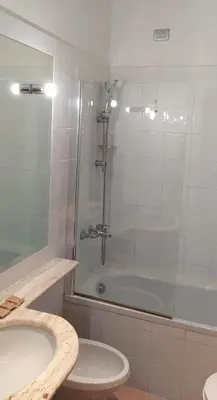 a bathroom with a shower and a toilet and a tub at LH Hotel Excel Roma Montemario in Rome