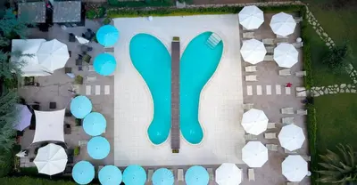 an overhead view of a parking lot with a green sign at LH Hotel Excel Roma Montemario in Rome