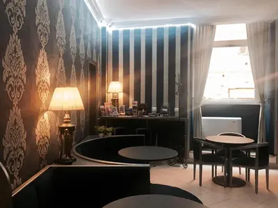 a waiting room with two tables and a window at Hotel Paris in Rome