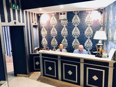 two men sitting at a bar in a lobby at Hotel Paris in Rome