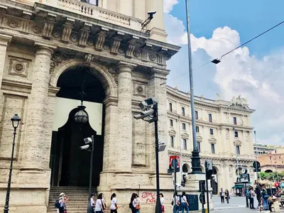 a large building with people walking in front of it at Hotel Paris in Rome