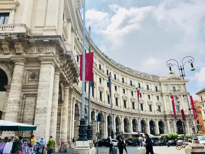 a large building with people walking in front of it at Hotel Paris in Rome