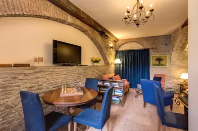 a living room with a table and blue chairs at Hotel Santa Maria in Rome