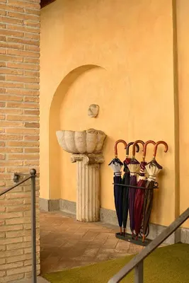a group of umbrellas hanging on a wall at Hotel Santa Maria in Rome