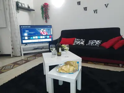 a living room with a couch and a table with wine glasses at Praetorian apartment in Rome