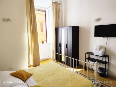 a bedroom with a bed and a black cabinet at Praetorian apartment in Rome