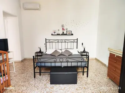 a bedroom with a black bed in a room at Praetorian apartment in Rome