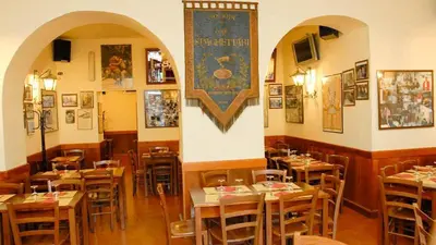a restaurant with tables and chairs in a room at Locanda San Cosimato in Rome