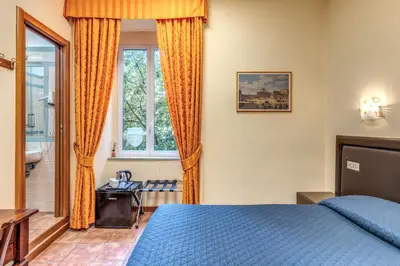 a bedroom with a blue bed and a window at Locanda San Cosimato in Rome