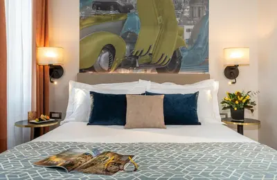 a bedroom with a bed with two magazines on it at Leonardo Boutique Hotel Rome Termini in Rome