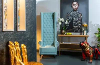 a room with a chair and a statue of a woman at Leonardo Boutique Hotel Rome Termini in Rome