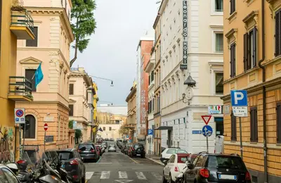 a busy city street with cars parked on the street at Leonardo Boutique Hotel Rome Termini in Rome