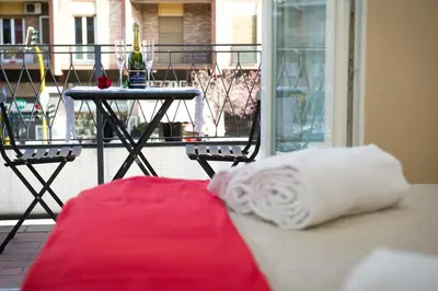 a white pillow sitting on a couch on a balcony at House Gregorio in Rome