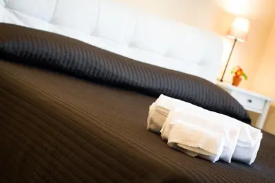 a close up of a bed with a pillow on it at House Gregorio in Rome