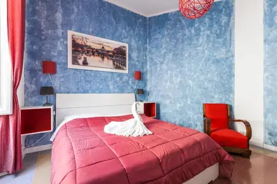a bedroom with a red bed and a red chair at The Sweet Terrace in Rome