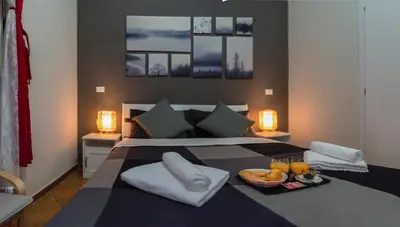 a bedroom with a bed with a tray of food on it at Martini Rooms in Rome