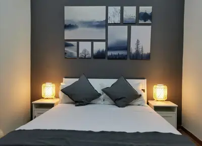 a bedroom with a bed with two lamps on two tables at Martini Rooms in Rome