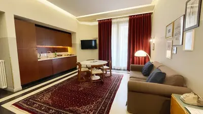 a living room with a couch and a table at Vino e Oli Residenze in Rome