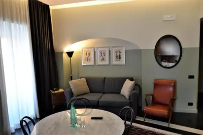 a living room with a couch and a table at Vino e Oli Residenze in Rome