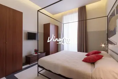 a hotel room with a bed with a large mirror at Vino e Oli Residenze in Rome