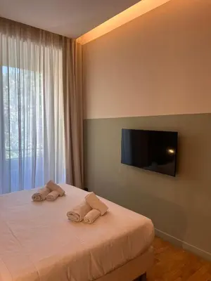 a bedroom with a bed with two towels on it at Vino e Oli Residenze in Rome