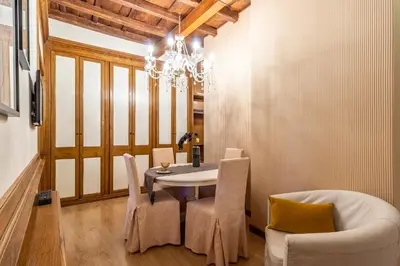 a dining room with a table and chairs and a chandelier at Spagna Historical by Spanish Steps in Rome