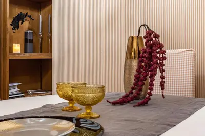 a table with a plate and a gold vase and beads at Spagna Historical by Spanish Steps in Rome