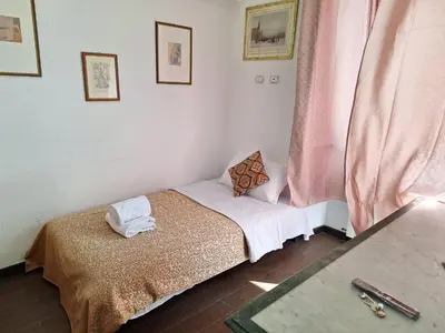 a small bedroom with a bed and a window at Casa Fanti 57 in Rome