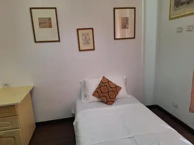 a room with a white bed with a pillow on it at Casa Fanti 57 in Rome