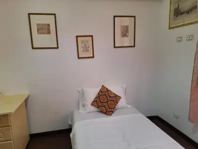 a bedroom with a white bed with a pillow on it at Casa Fanti 57 in Rome