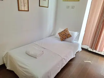 a white bed with two pillows on top of it at Casa Fanti 57 in Rome