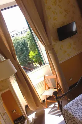 a bedroom with a large window and a tv at Casa Fanti 57 in Rome