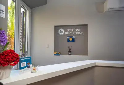 a room with a window with a sign that reads support first rooms at Scipioni Best Rooms in Rome