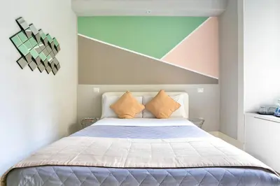 a bedroom with a bed with orange pillows at Scipioni Best Rooms in Rome