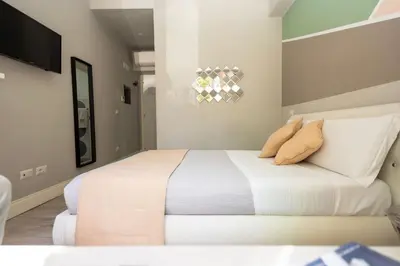 a bedroom with a bed with two pillows on it at Scipioni Best Rooms in Rome