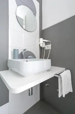 a bathroom with a white sink and a mirror at Scipioni Best Rooms in Rome