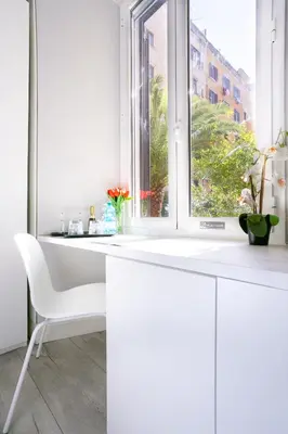a white desk in a white room with a window at Scipioni Best Rooms in Rome