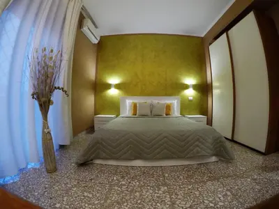 a bedroom with a bed and a vase of flowers at Roman Holidays House Marconi in Rome