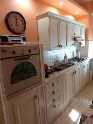 a kitchen with a stove and a clock on the wall at Roman Holidays House Marconi in Rome