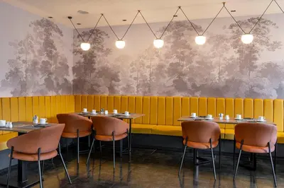 a row of tables and chairs in a restaurant at H10 Roma Città in Rome