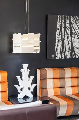 a living room with a table and a chandelier at H10 Roma Città in Rome