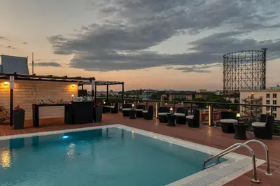 a swimming pool on the roof of a building at H10 Roma Città in Rome