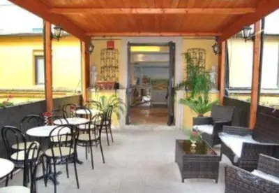 a patio with tables and chairs and a restaurant at Hotel Nardizzi Americana in Rome