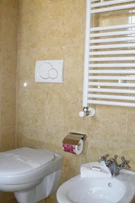 a bathroom with a white toilet and a sink at Hotel Villa Pinciana in Rome